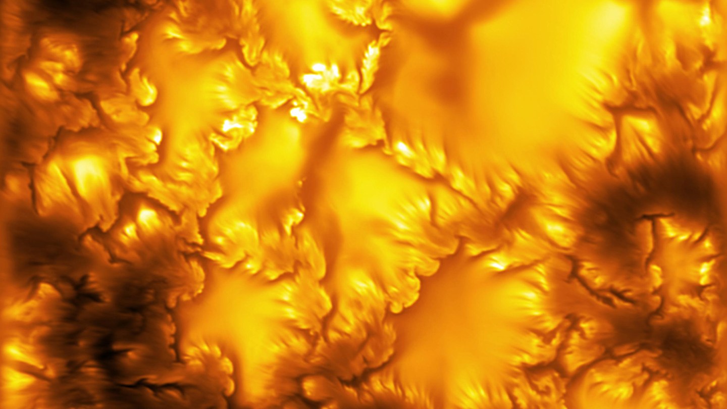 a segment of the sun's surface with jagged lines and shades of orange swirls