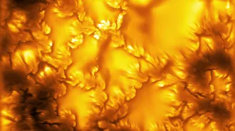 a segment of the sun's surface with jagged lines and shades of orange swirls