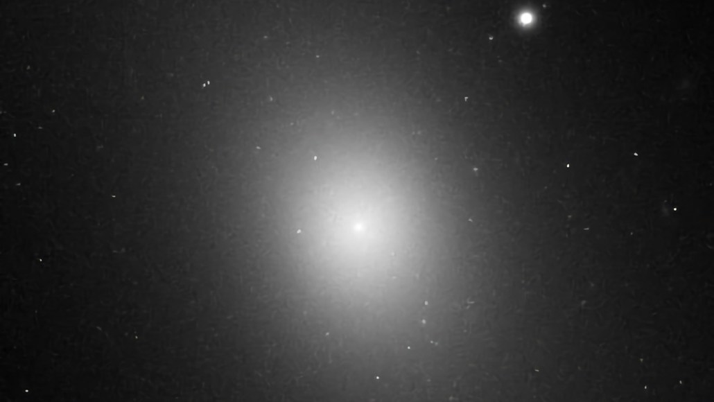 A bright ellipse shines amid the black backdrop of space.