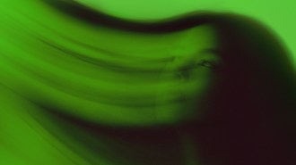 A swirly, artistic green image of a woman's head.