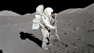A photo of an astronaut in a space suit collecting a regolith sample on the moon's surface.